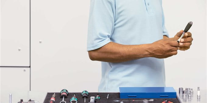 A man is performing maintenance on tools. A man is performing maintenance on tools.