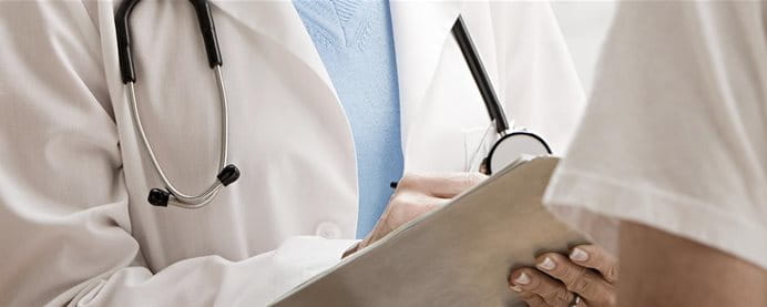 A doctor and his patient having a conversation. A doctor and his patient having a conversation.