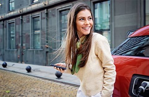 Woman at charging station Woman at charging station