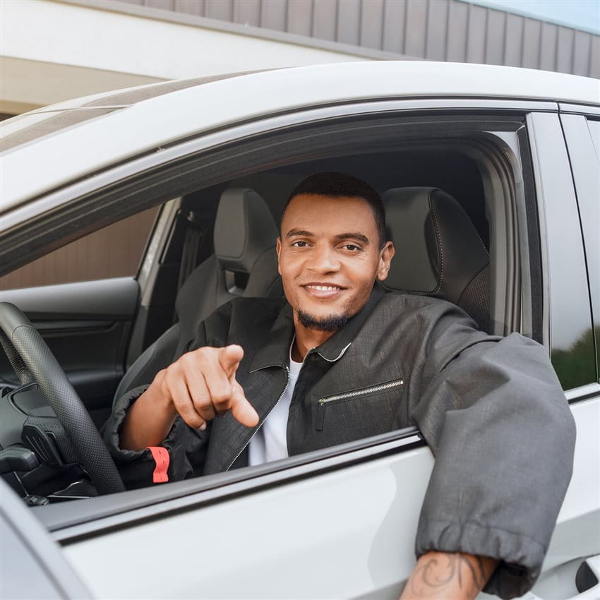 Manuel Akanji is sitting in the driver's seat of a car and pointing forward. Manuel Akanji is sitting in the driver's seat of a car and pointing forward.