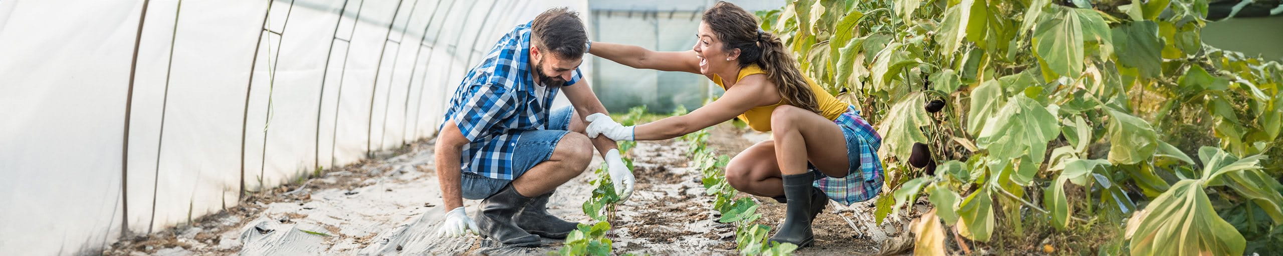 Eine Frau hält einen Mann am Arm und lacht