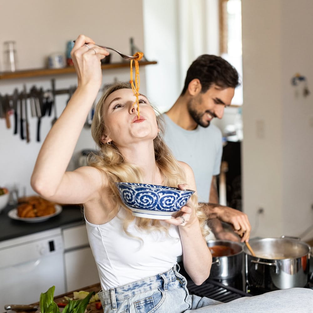 A couple cooking in the kitchen