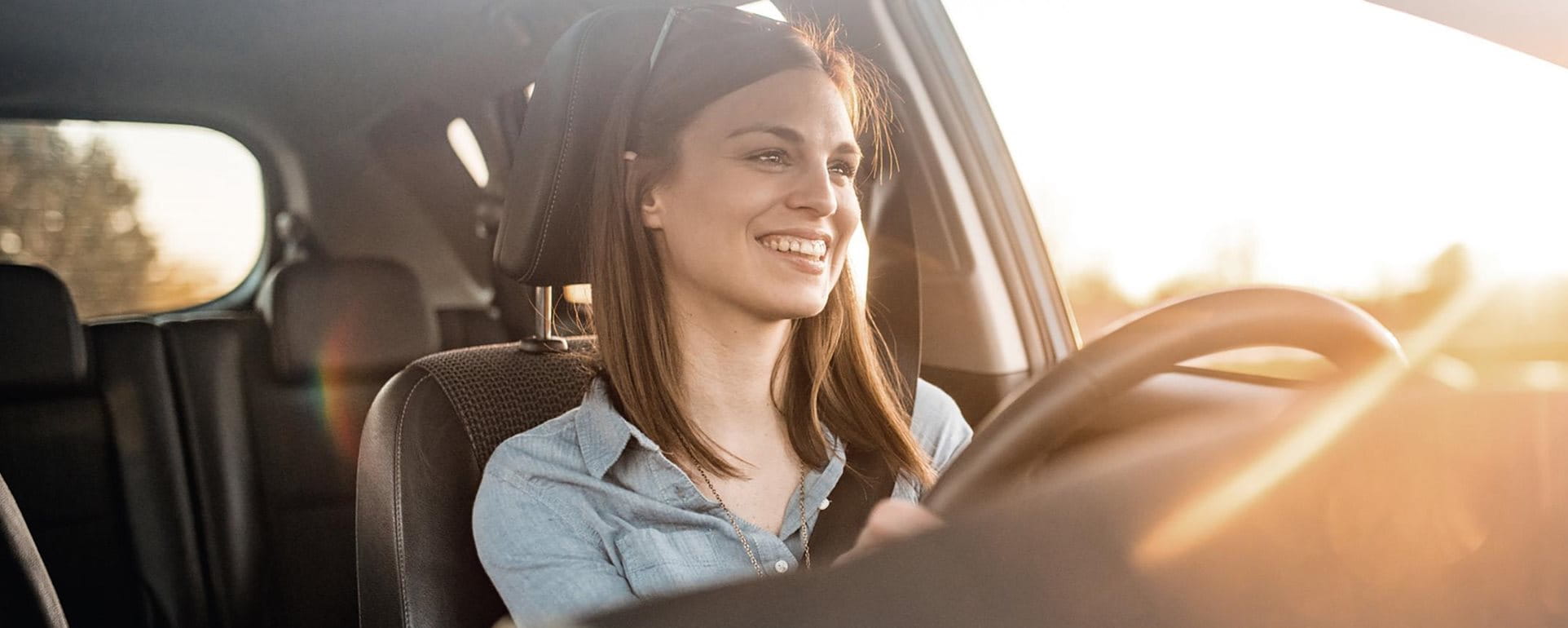 Young woman sitting at the wheel of a car Young woman sitting at the wheel of a car