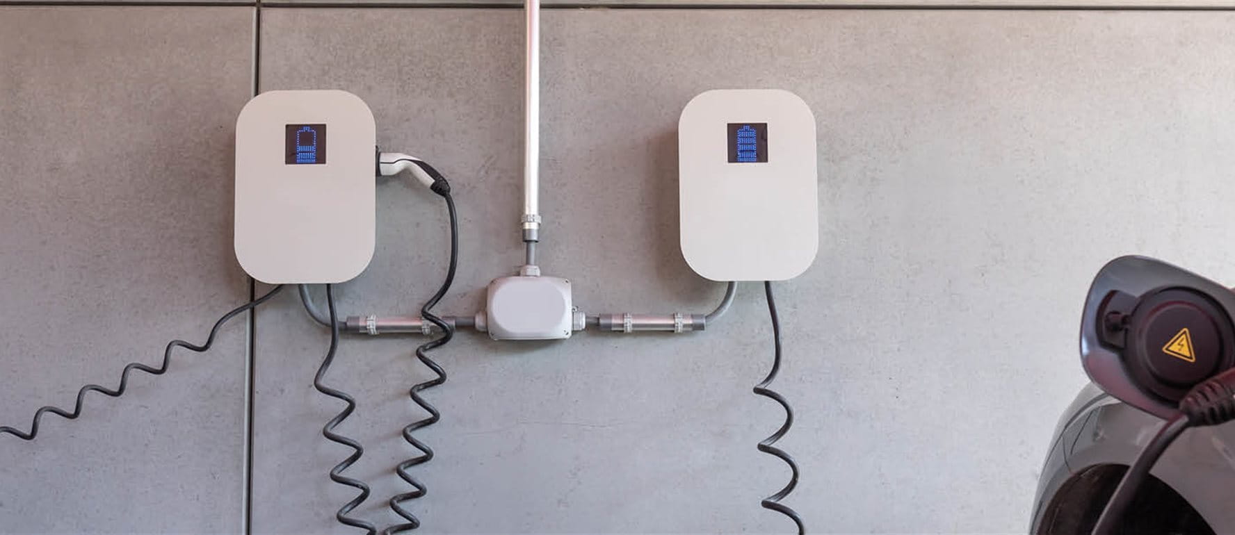 Electric car charging at wallbox Electric car charging at wallbox