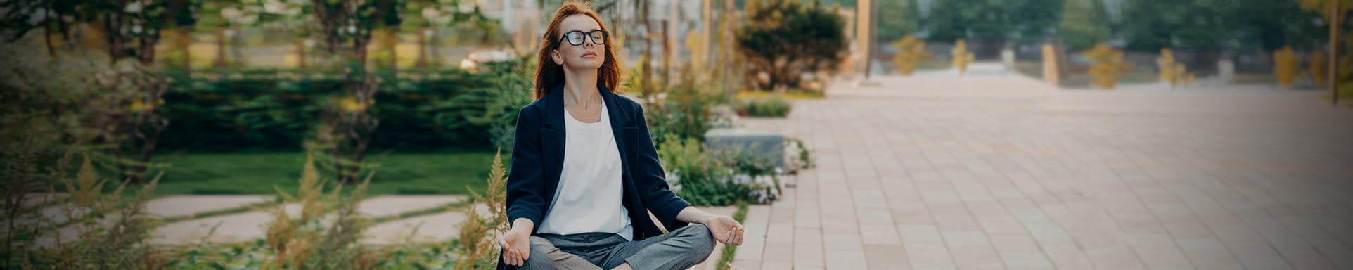 La femme s'assied en parc et fait le yoga  La femme s'assied en parc et fait le yoga