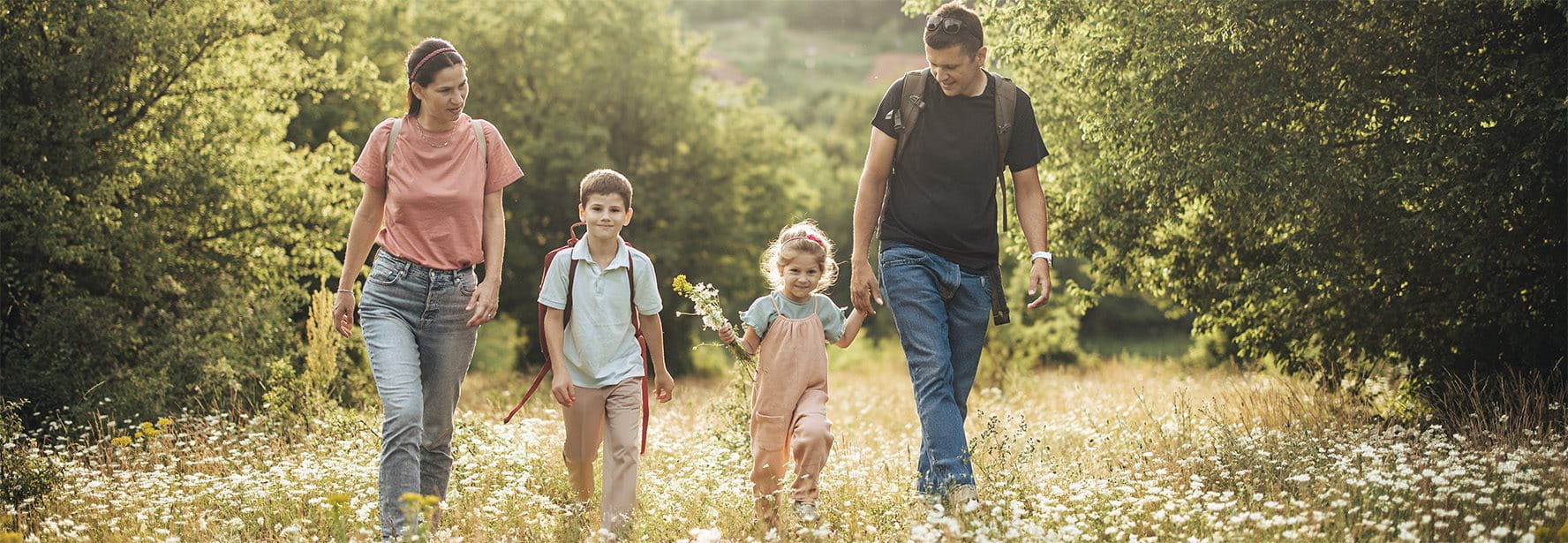 Family walks across a meadow