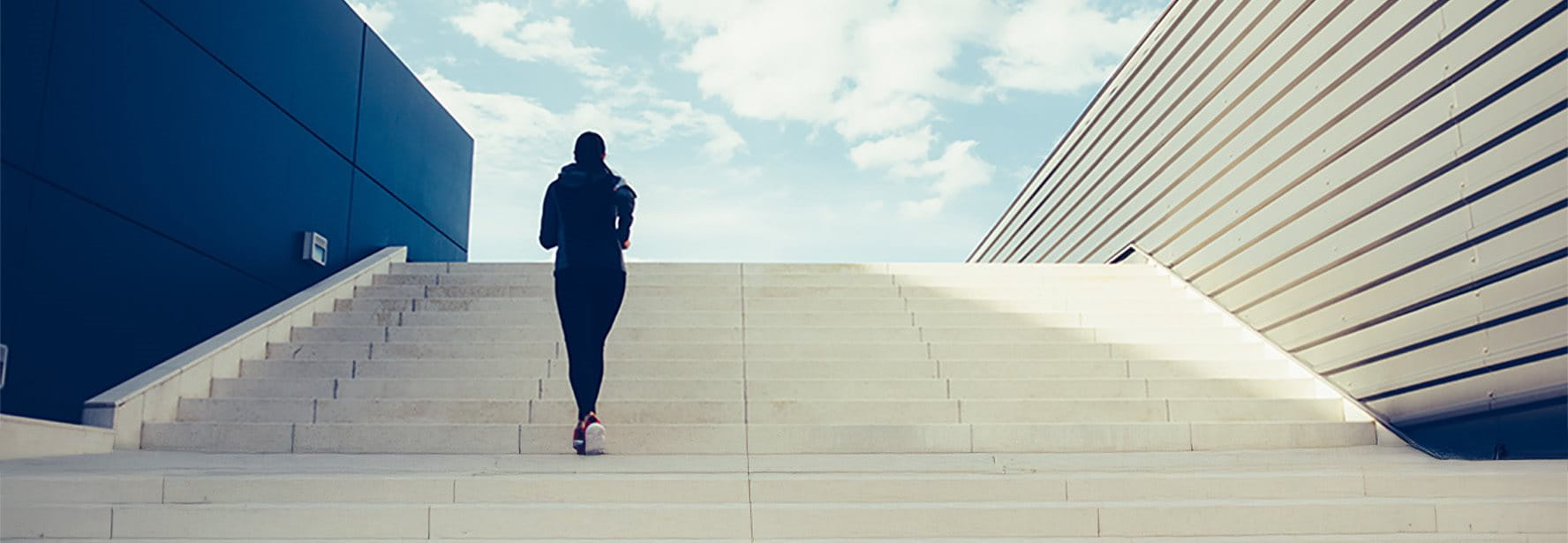 Woman runs up the stairs with a flourish