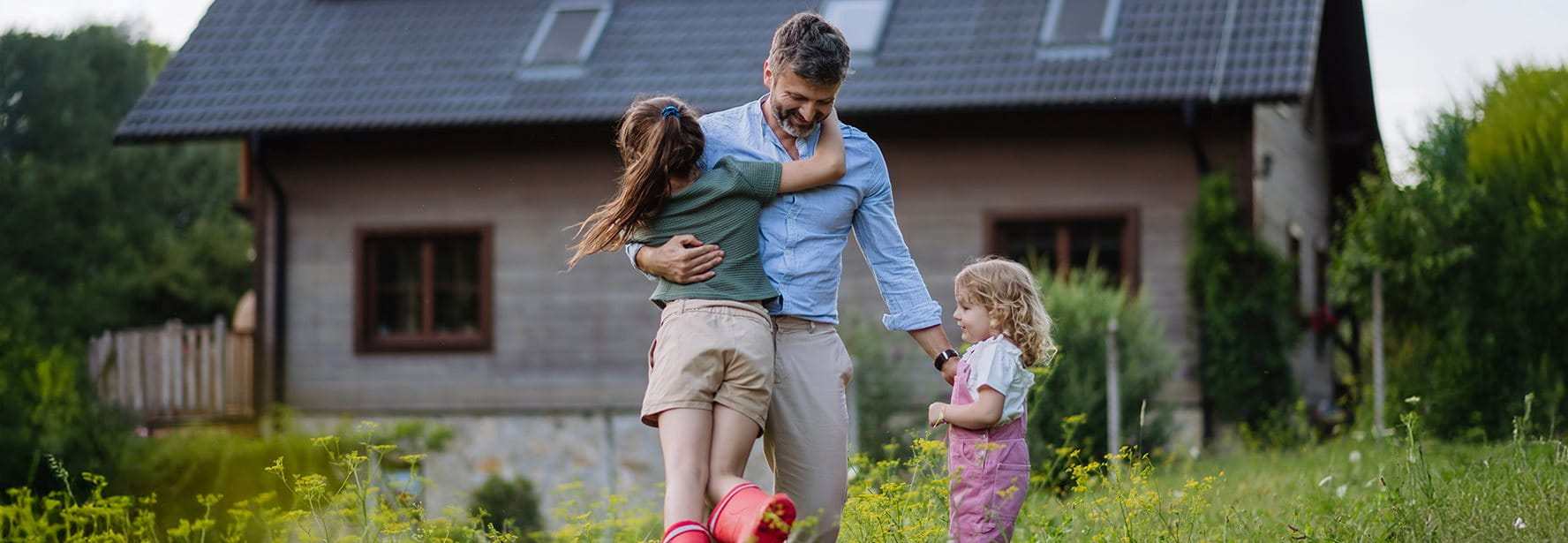 Father playing with his children in the meadow
