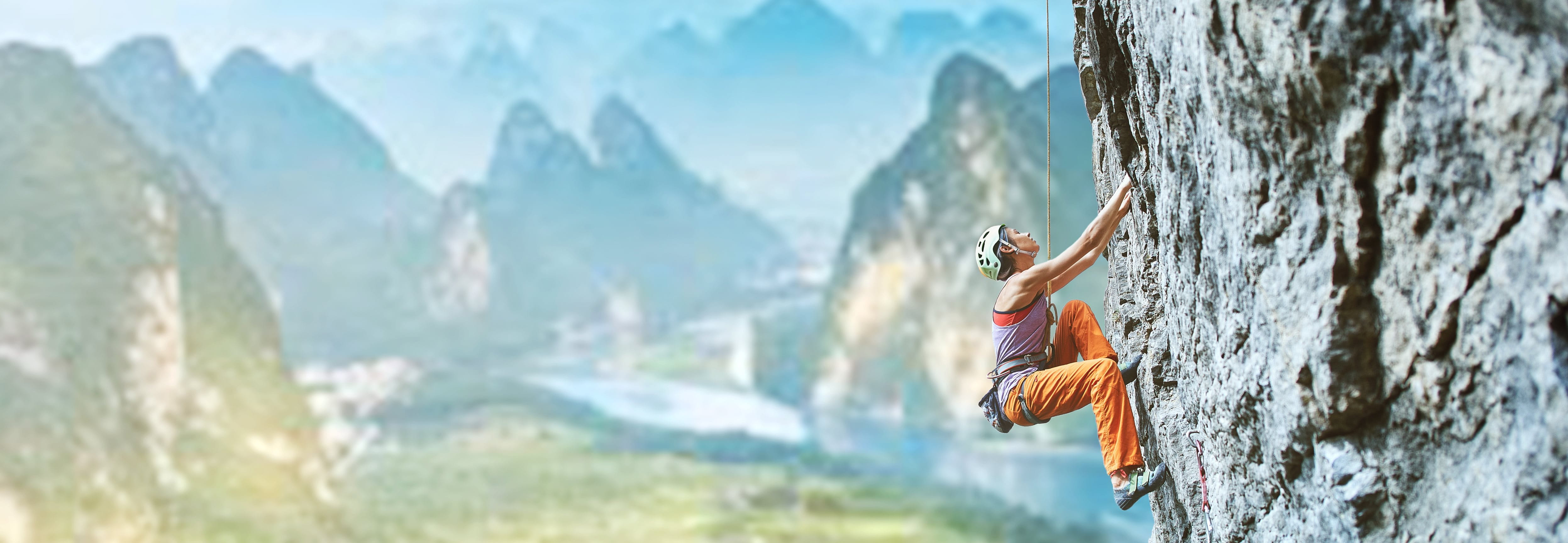 Mountaineer climbing on a rock