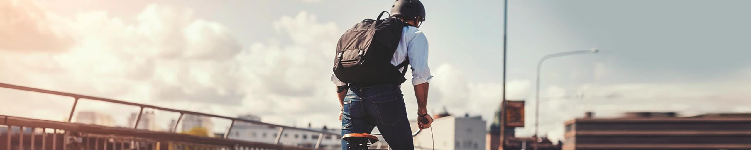 Man riding a bicycle over a bridge