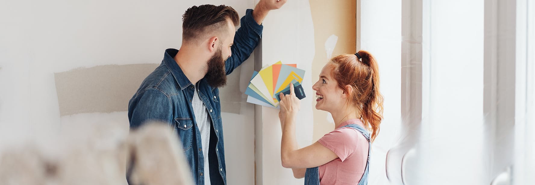 Due persone scelgono i colori durante una ristrutturazione.