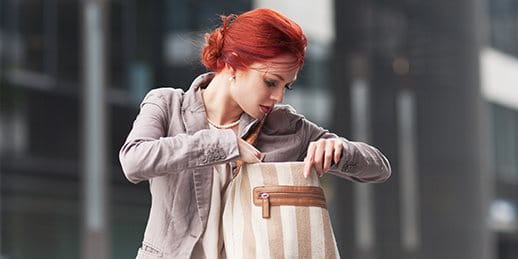 Woman searching for a key in her bag. Woman searching for a key in her bag.