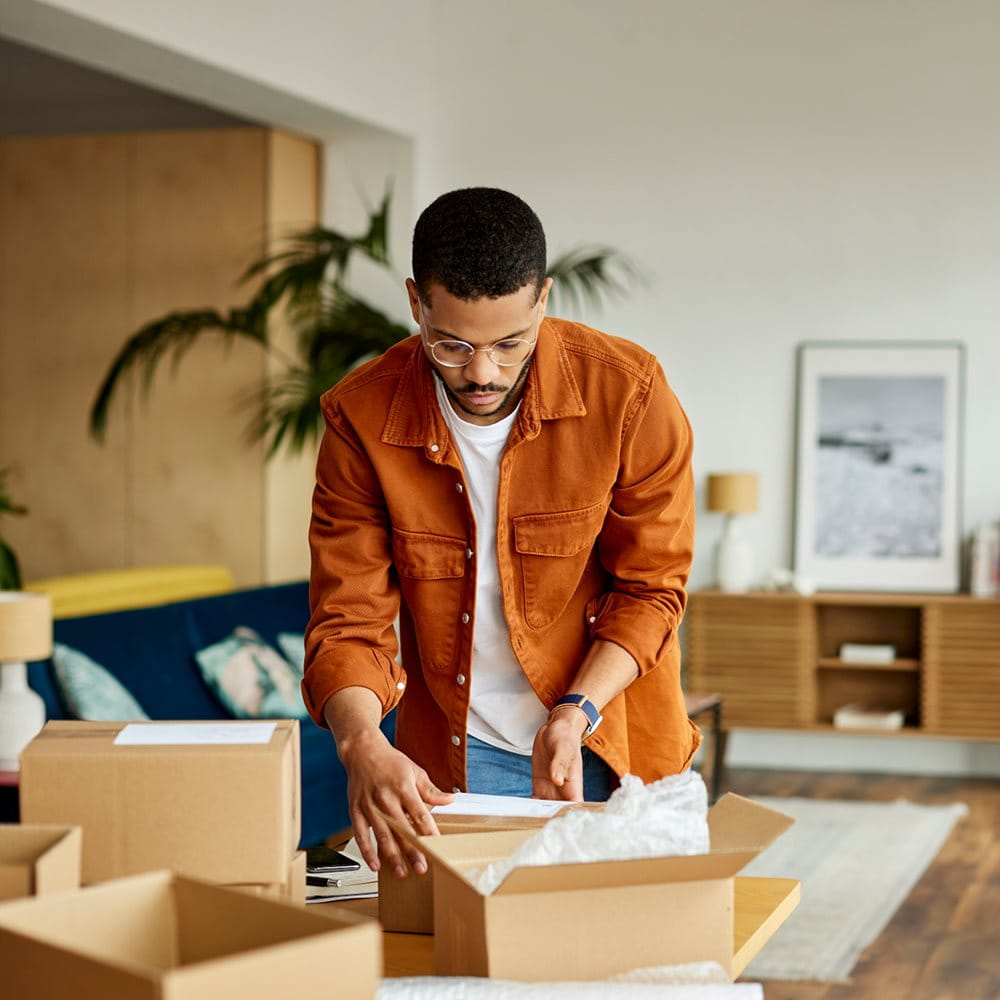 Man fills moving box