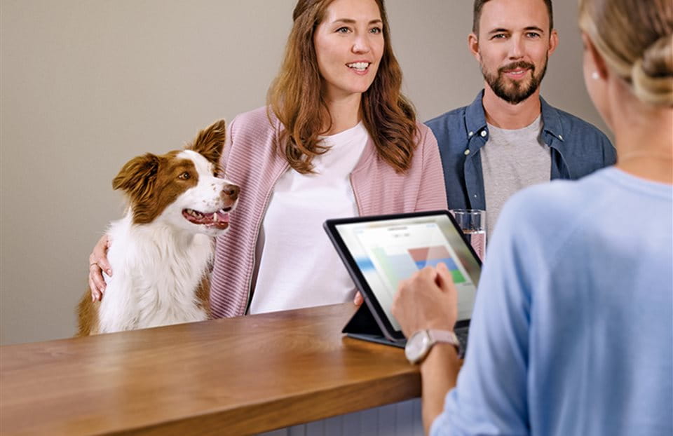 Frau und Mann mit Hund in Vorsorgeberatung Frau und Mann mit Hund in Vorsorgeberatung