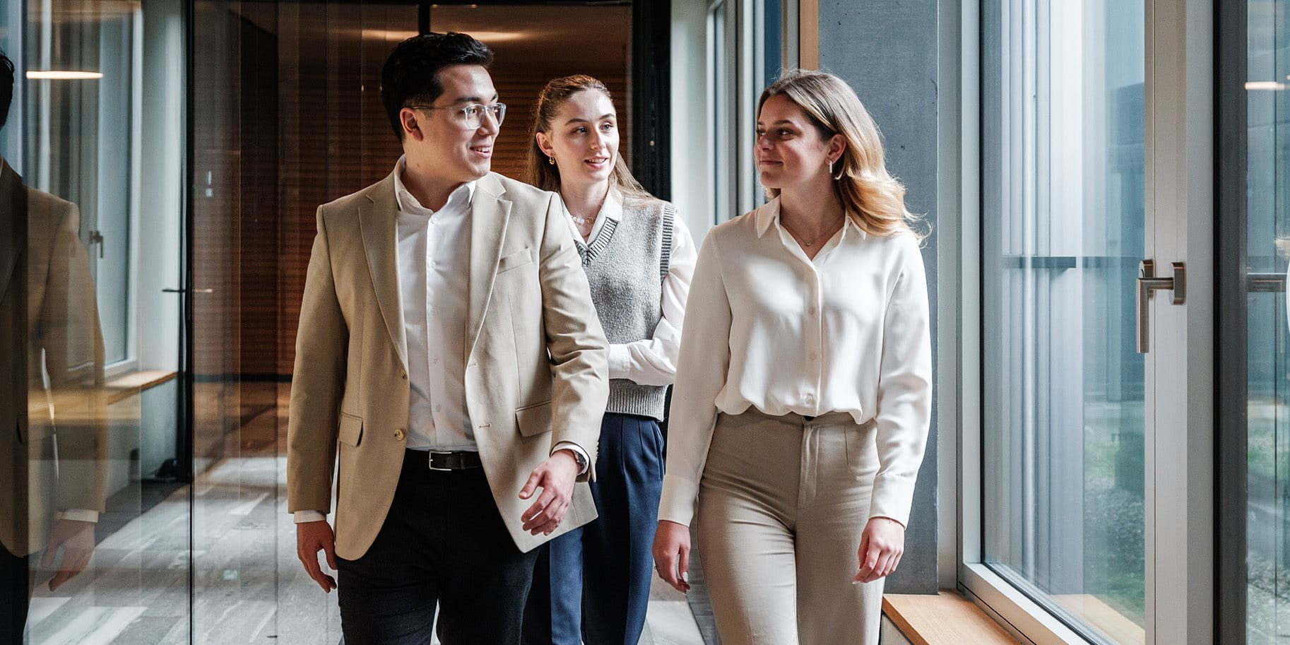 Three high school graduates are running through the office.