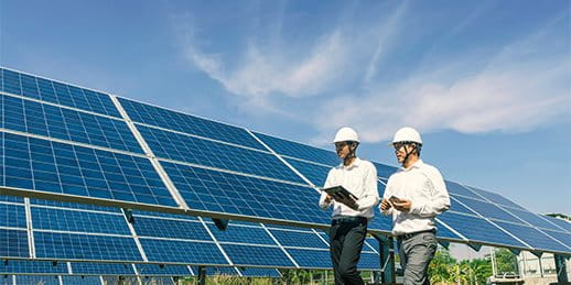 Two engineers in front of solar electricity panel