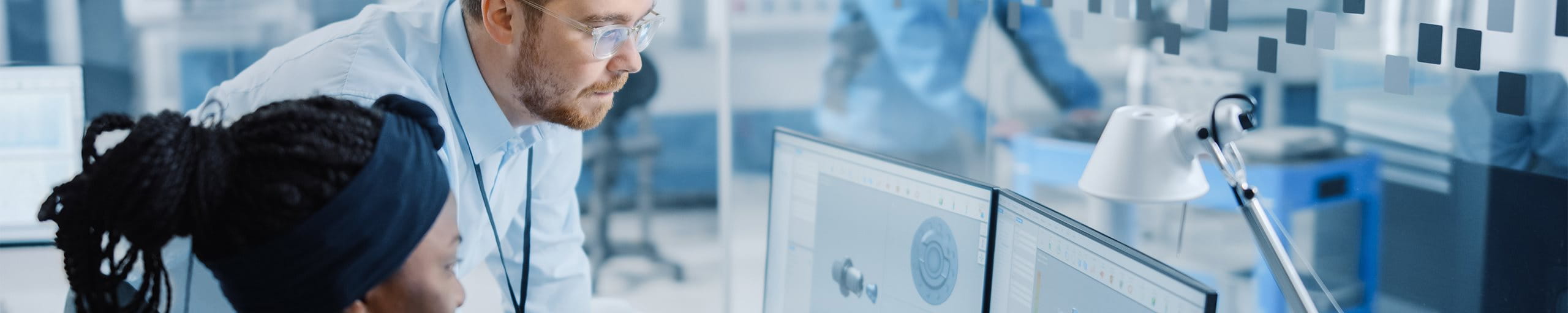 Two people looking into a screen