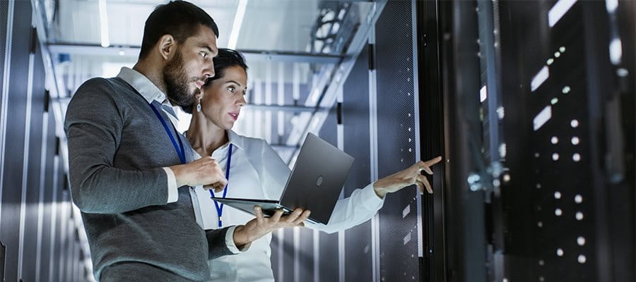 IT specialists in front of a computer server